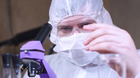 Scientist uses a microscope for scientific research. Researcher in laboratory. 스톡 동영상 122764359