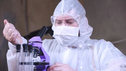 Scientist uses microscope for scientific research. Ecology biological experiment Stock-Footage 122764531