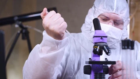 Scientist uses microscope for scientific research. Ecology biological experiment Stock-Footage 122764706