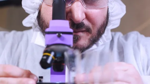 Scientist uses microscope for scientific research. Ecology biological experiment Stock-Footage 122765015