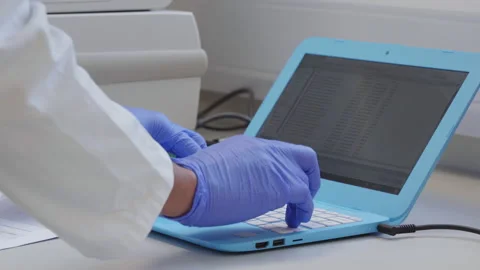 Scientist uses a work computer to input data Stock Footage 202118495