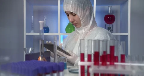 Scientist using digital tablet and working with samples in the laboratory Video stock 129695732