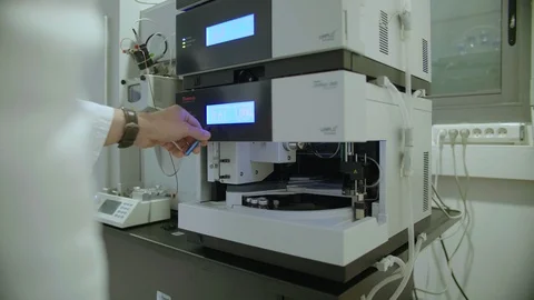 Scientist using a DNA sequencer in a laboratory Stock Footage