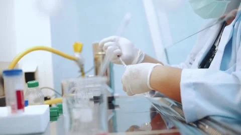 Scientist using dropper pipette transfer sample in Biosafety cabinet	 Stock Footage 133444853