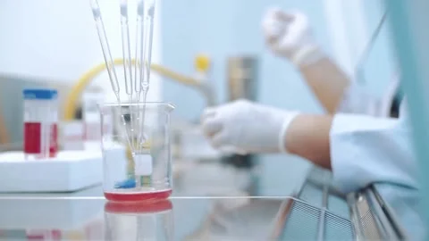 Scientist using dropper pipette transfer sample in Biosafety cabinet	 Stock Footage 134551179