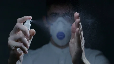Scientist using hand sanitizer alcohol spray Stock Footage 126357172