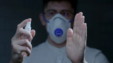 Scientist using hand sanitizer alcohol spray Stock Footage 126357196