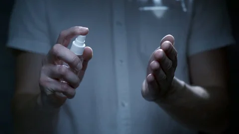 Scientist using hand sanitizer alcohol spray Stock Footage 126357218
