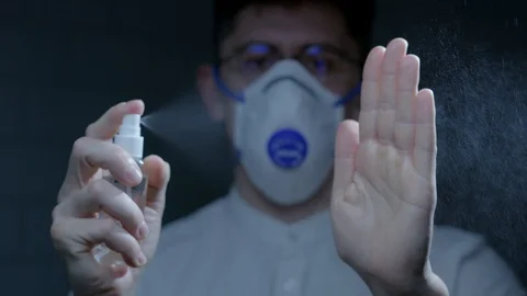 Scientist using hand sanitizer alcohol spray Stock Footage 126357219