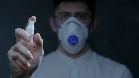 Scientist using hand sanitizer alcohol spray Stock Footage 126357223