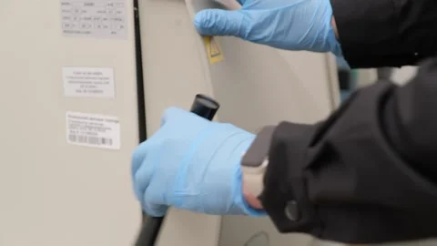 Scientist Using Laboratory Autoclave for Sterilization Stock Footage 302888739