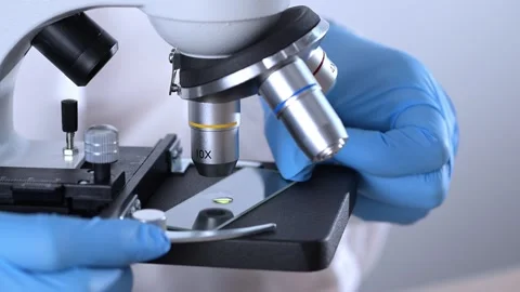 Scientist using laboratory microscope. Doctor using medicine microscope in .. Stock Footage 268874024