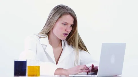 Scientist using laptop and studying liquids Video stock 80131690