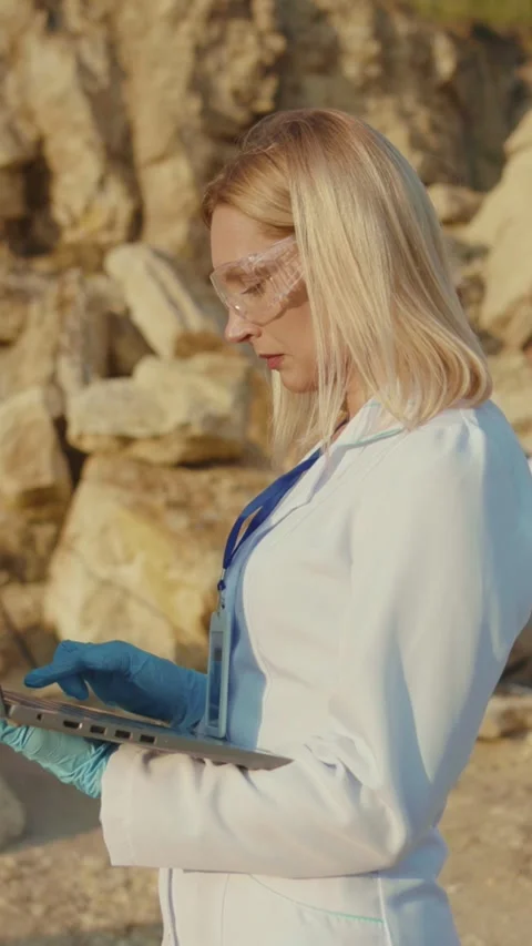 A scientist is using a laptop outdoors for important research studies and Stock Footage 314207549
