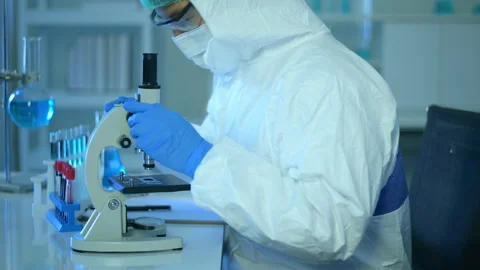 Scientist using microscope during experiment in laboratory 스톡 동영상 146183541