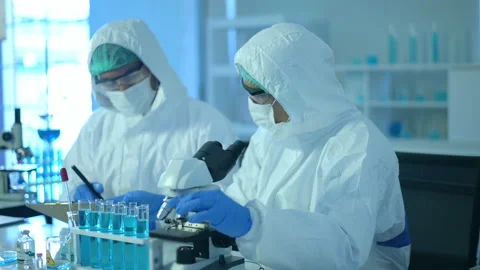 Scientist using microscope during experiment in laboratory Vídeo Stock 146183813