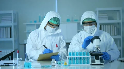 Scientist using microscope during experiment in laboratory 動画素材 146183819