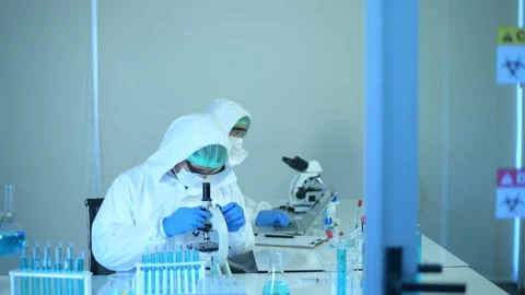 Scientist using microscope during experiment in laboratory 動画素材 146183937