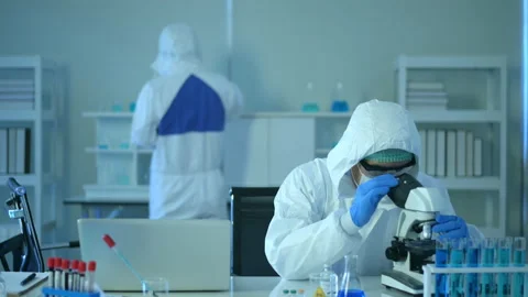 Scientist using microscope during experiment in laboratory Vídeos de archivo 146185262