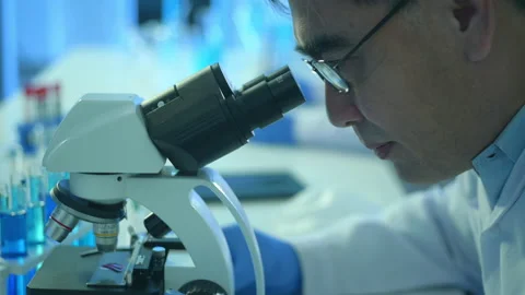Scientist using microscope during experiment in laboratory Vídeos de archivo 146185280