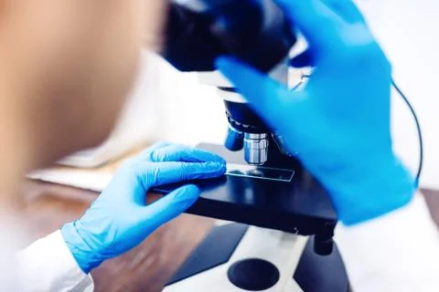 Scientist using microscope to examin small chemical probes. Medical equipment Stock Photos