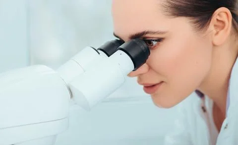Scientist using microscope in lab, close-up. Laboratory technician while work Foto stock