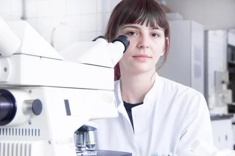Scientist using microscope in lab Stock Photos