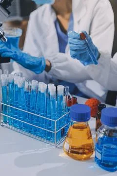 Scientist using microscope in laboratory. Close-up of a researcher's hands .. Stock Photos