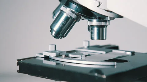 Scientist using a microscope in laboratory Stock Footage 56354588