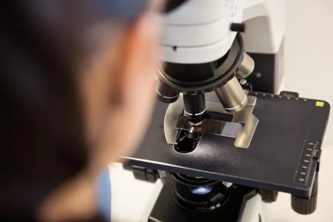 Scientist Using Microscope In Laboratory Stock Photos