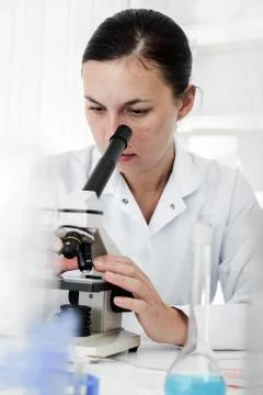 Scientist using a microscope in a laboratory Foto stock
