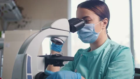 Scientist Using a Microscope in a Laboratory. In Search of a Vaccine Against Stock Footage 144675266