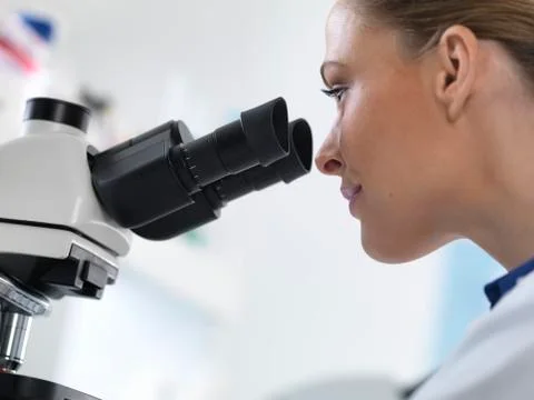 Scientist using microscope Stock Photos