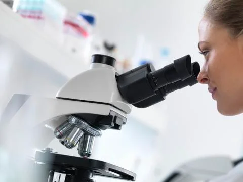 Scientist using microscope Stock Photos