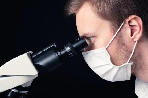 Scientist using microscope Stock Photos