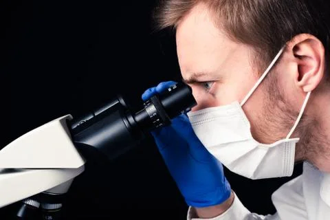 Scientist using microscope Stock Photos