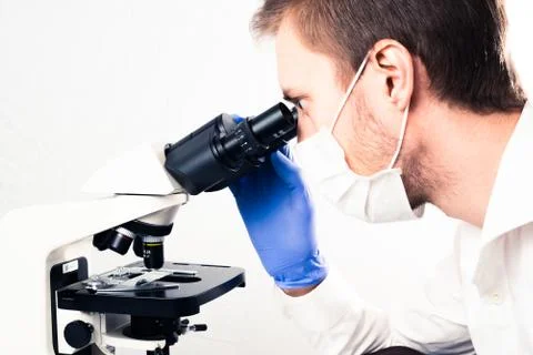 Scientist using microscope Stock Photos