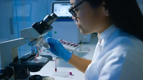 Scientist using a microscope Stock Photos