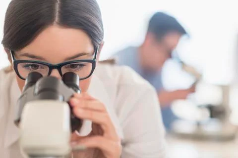 Scientist using microscope in research laboratory Foto stock