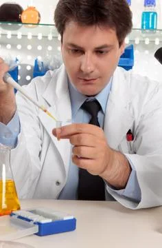 Scientist using pipette in lab Stock Photos