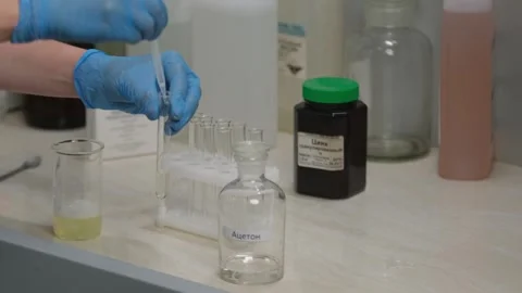 Scientist Using Pipette to Transfer Liquid in Laboratory Stock Footage 302888638