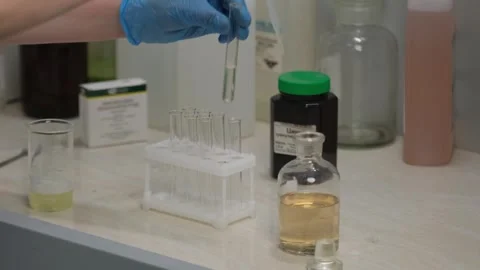 Scientist Using Pipette to Transfer Liquid in Laboratory Stock Footage 302888770