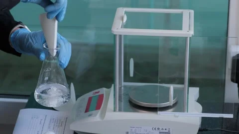 Scientist Using Pipette to Transfer Liquid in Laboratory Stock Footage 303762580