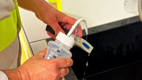 Scientist Using Refractometer for Water Quality Testing in Laboratory Stock Footage 334402766