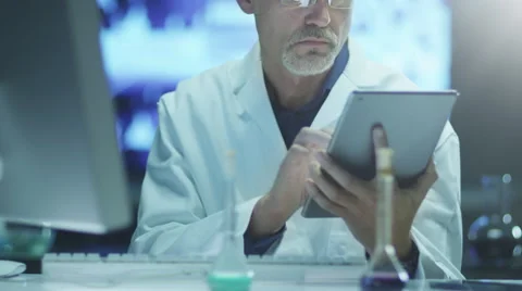 Scientist is Using Tablet in Laboratory Stock Footage 48638766