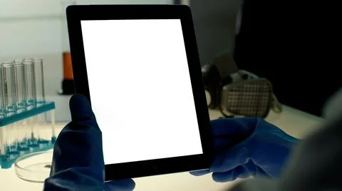 Scientist using tablet PC with blank white screen in modern laboratory 写真素材