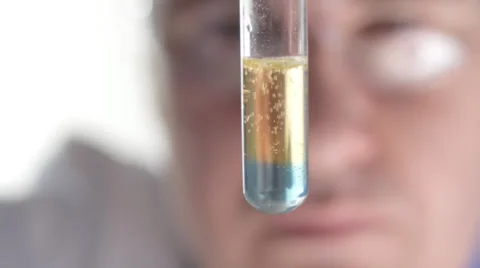 Scientist watching chemical reaction in test tube Stock Footage 35109860