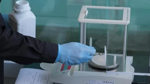 Scientist Weighing Sample on Laboratory Scale Stock Footage 302888702