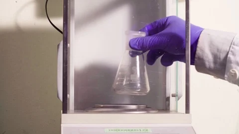 Scientist weighing a soil sample on high-precision analytical scales. Stock Footage 87951635