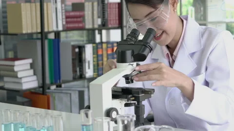 Scientist woman is looking microscope. Stock Footage 173594771